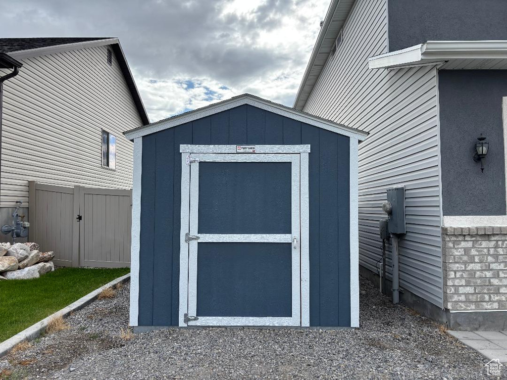 View of shed featuring fence