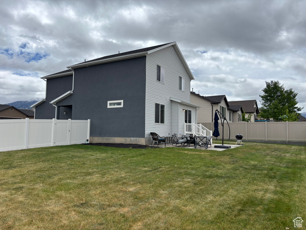 Rear view of property featuring a patio