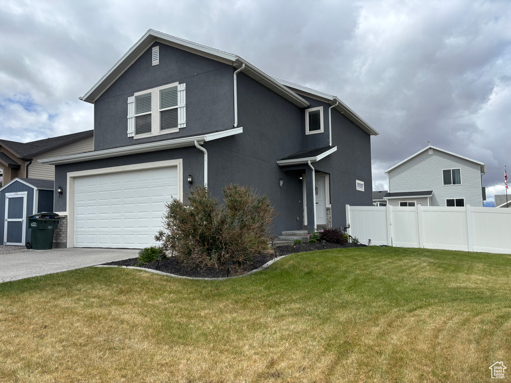 Traditional home with concrete driveway, a garage, and stucco siding