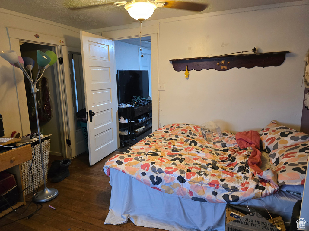Bedroom featuring dark wood-style flooring and a ceiling fan