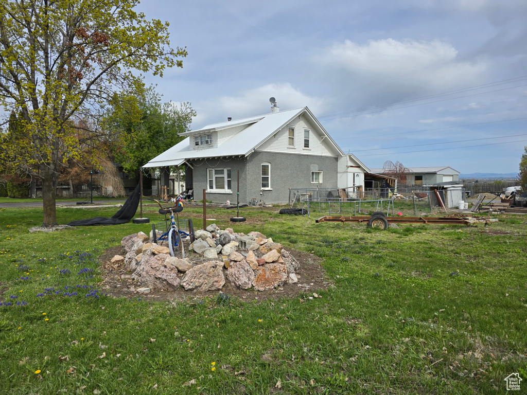 Back of house featuring stucco siding