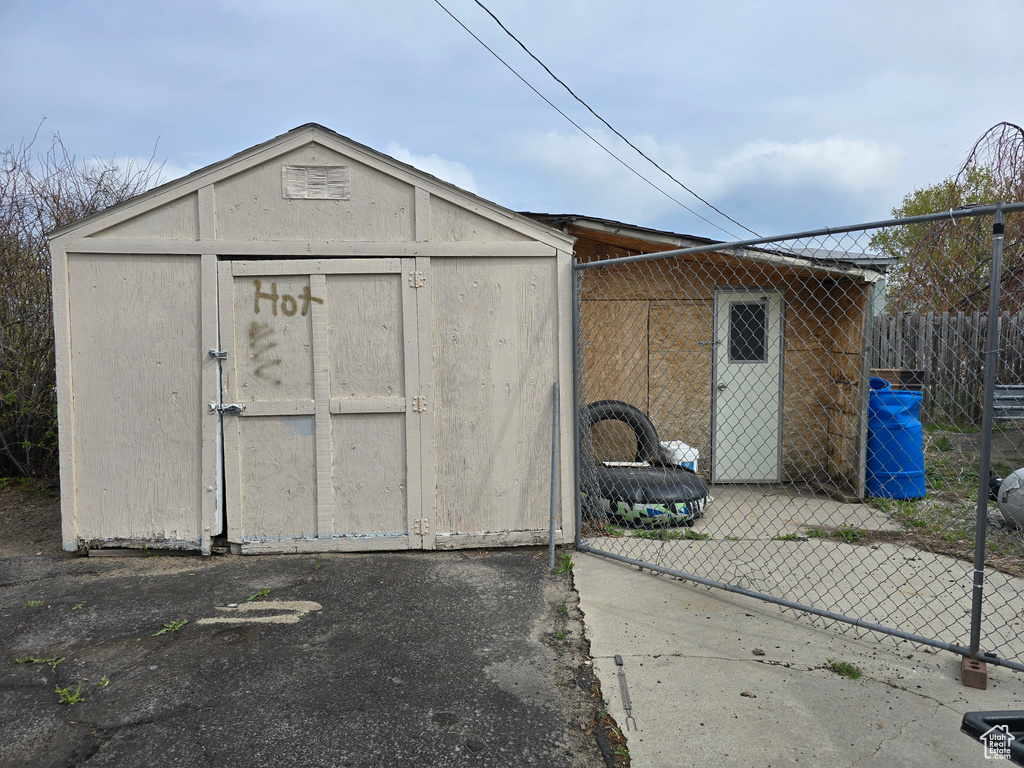 View of shed featuring fence
