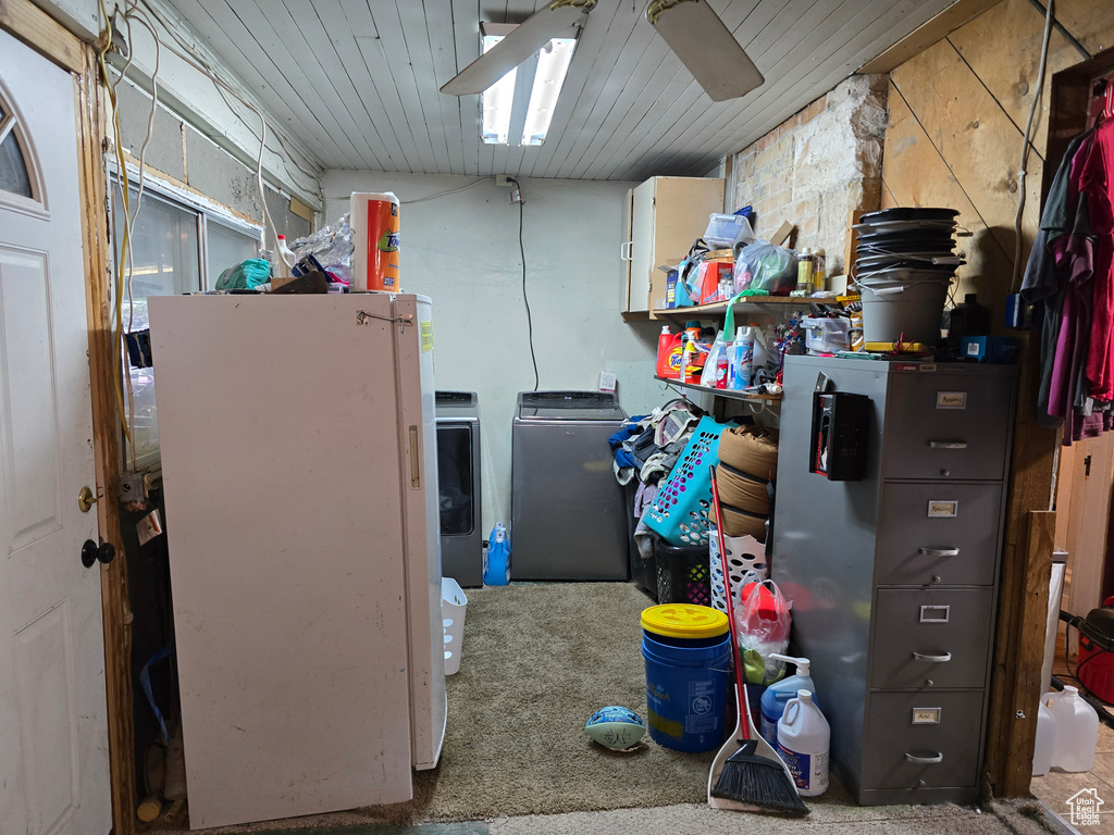 Storage area featuring washing machine and clothes dryer and a ceiling fan