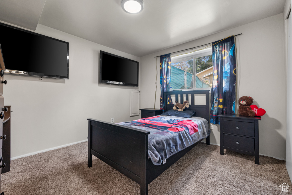 Bedroom featuring carpet floors and baseboards