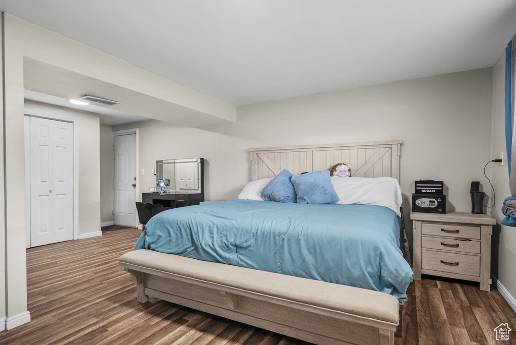Bedroom featuring wood finished floors and baseboards