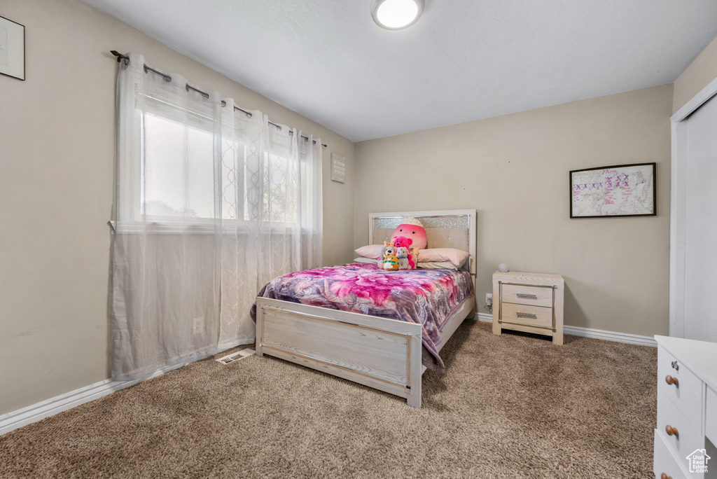Carpeted bedroom with baseboards