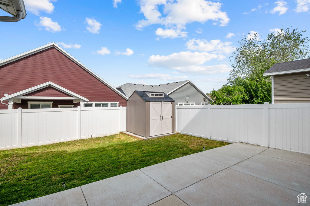View of yard with a patio, a shed, and an outdoor structure