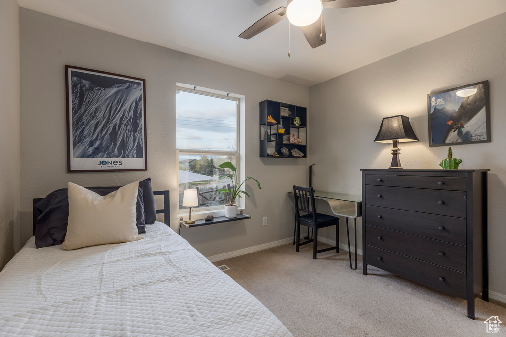 Carpeted bedroom with baseboards and ceiling fan