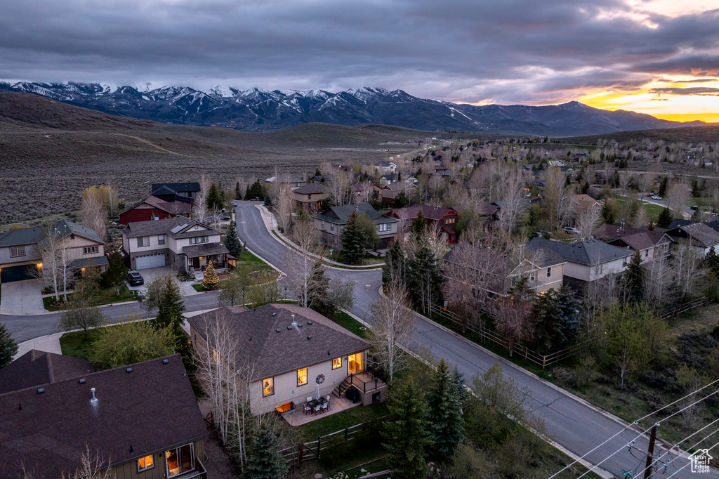 Aerial view of property's location with mountains and nearby suburban area