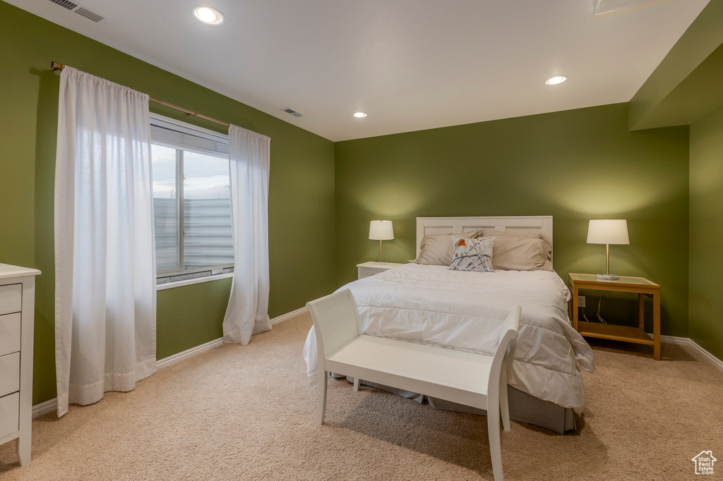 Bedroom featuring light carpet, baseboards, and recessed lighting