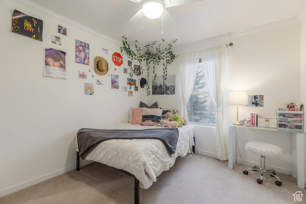 Bedroom with carpet, crown molding, baseboards, and a ceiling fan