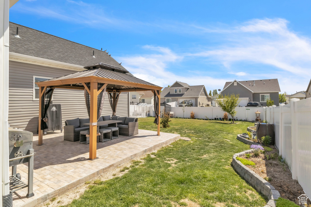 View of yard with an outdoor living space, a gazebo, a patio area, and a residential view