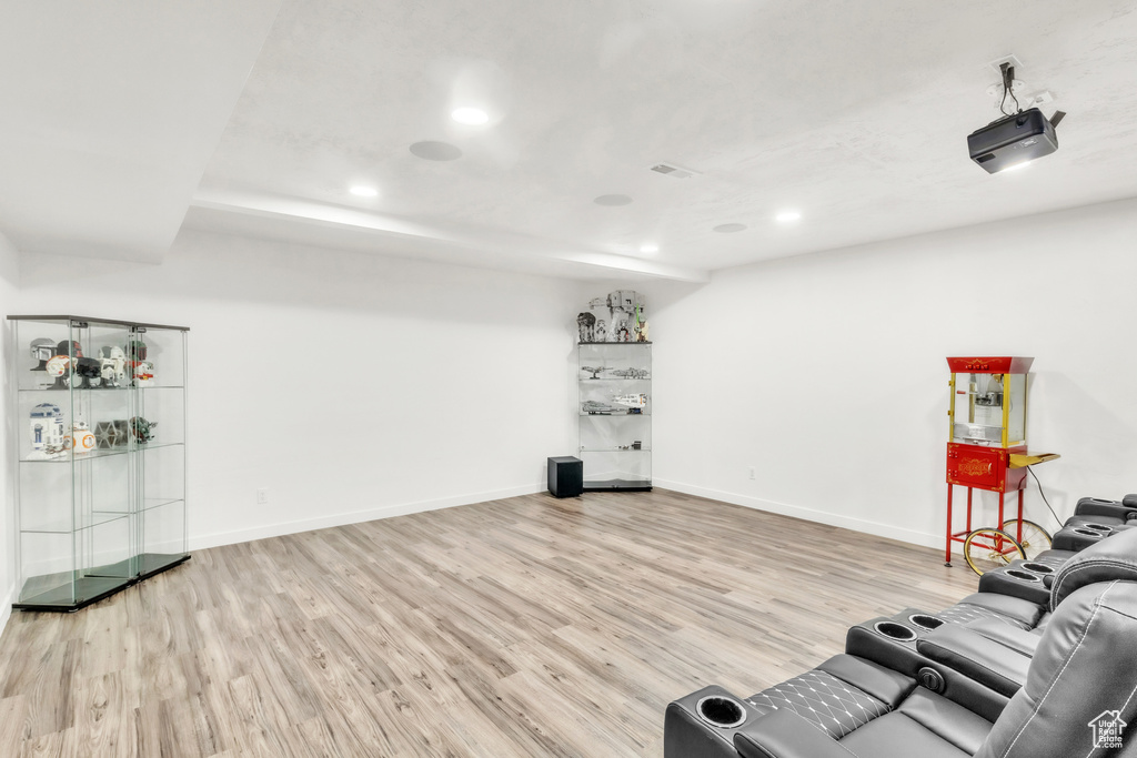 Unfurnished living room featuring wood finished floors, recessed lighting, and baseboards