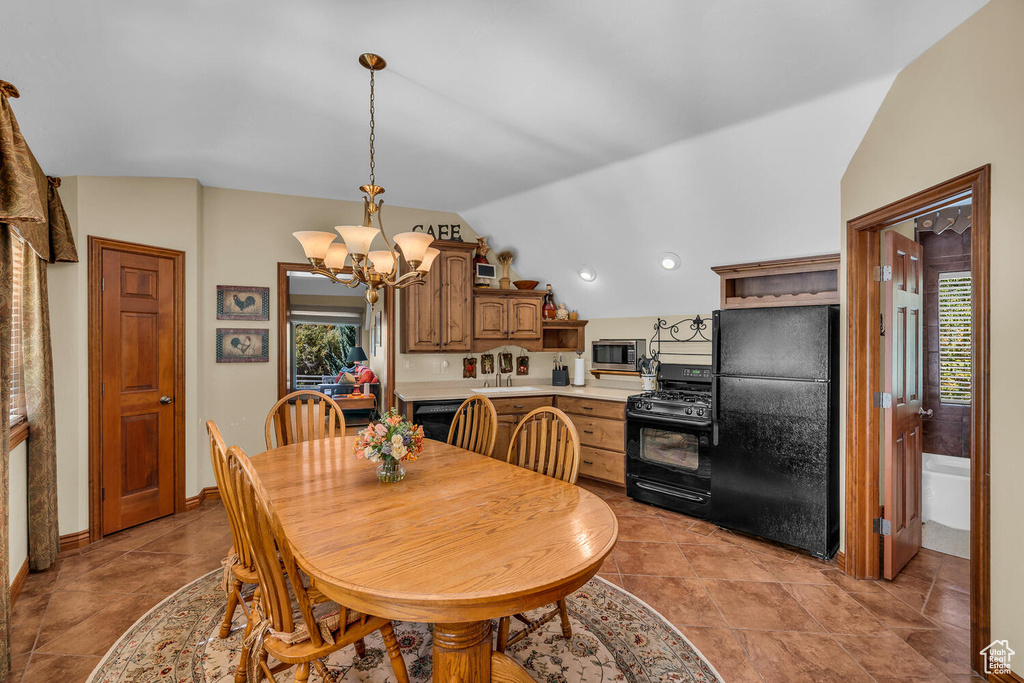 Dining area featuring lofted ceiling and a chandelier