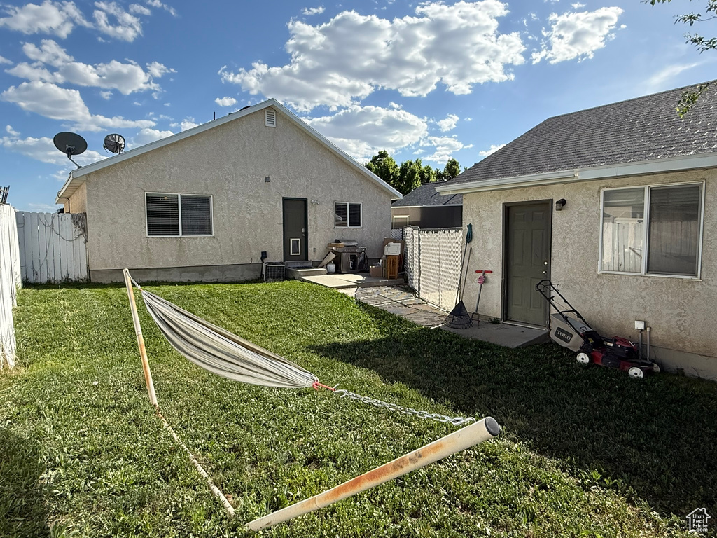 Back of property featuring stucco siding