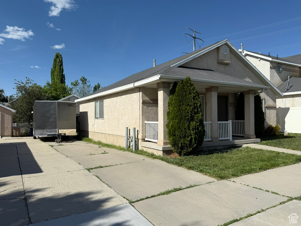 View of home\\\'s exterior with a porch and stucco siding