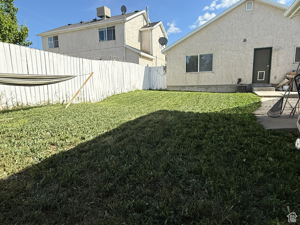 View of yard with central air condition unit and a patio area