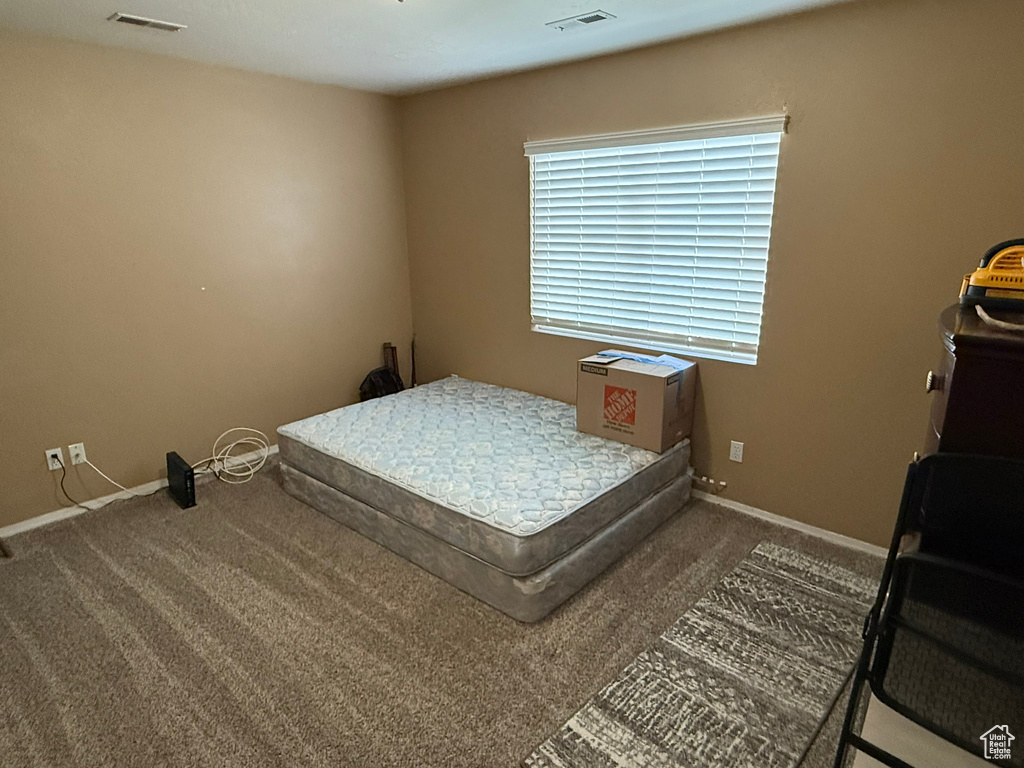 Bedroom featuring carpet flooring and baseboards