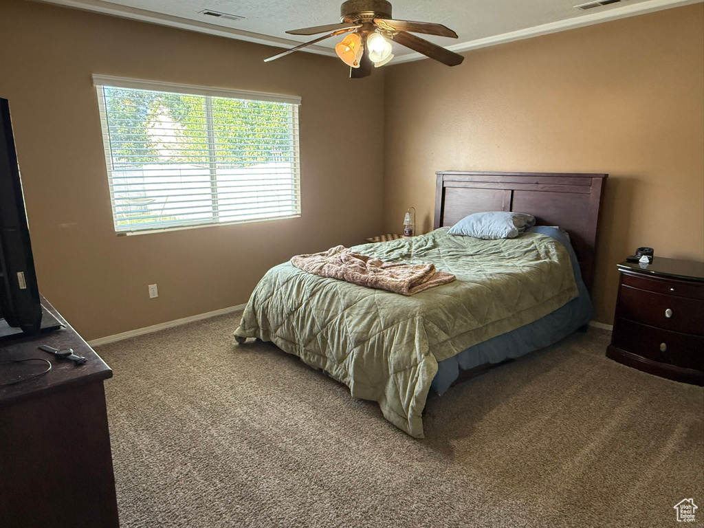 Bedroom featuring carpet flooring, baseboards, and a ceiling fan