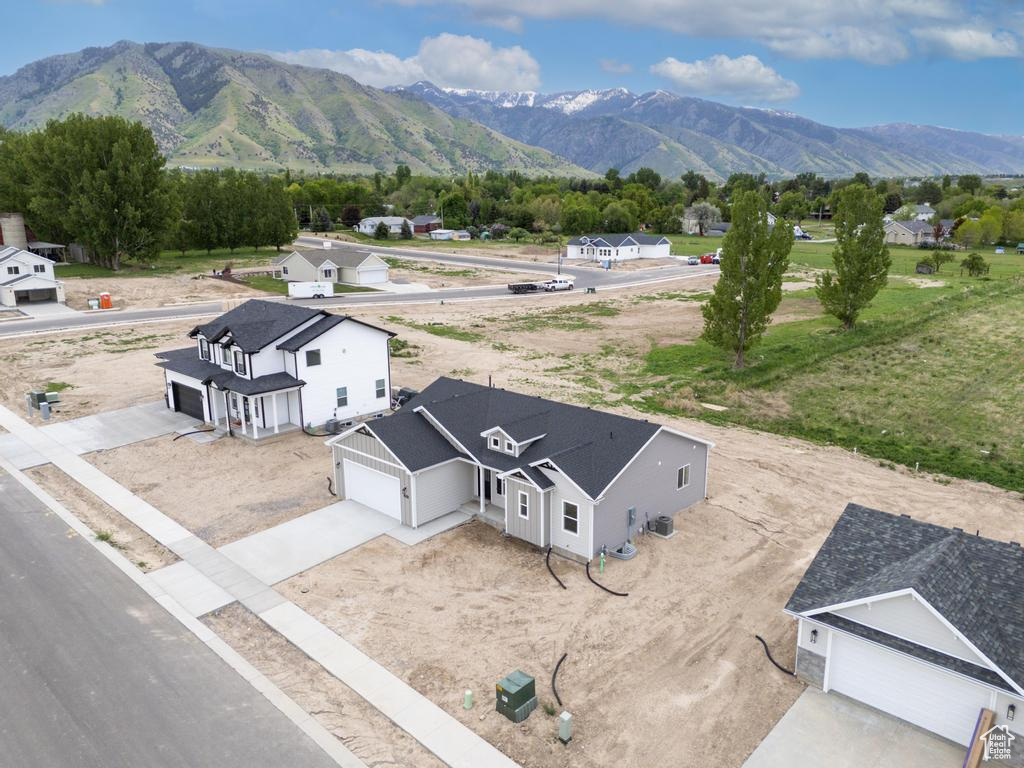 Aerial view of property and surrounding area featuring mountains