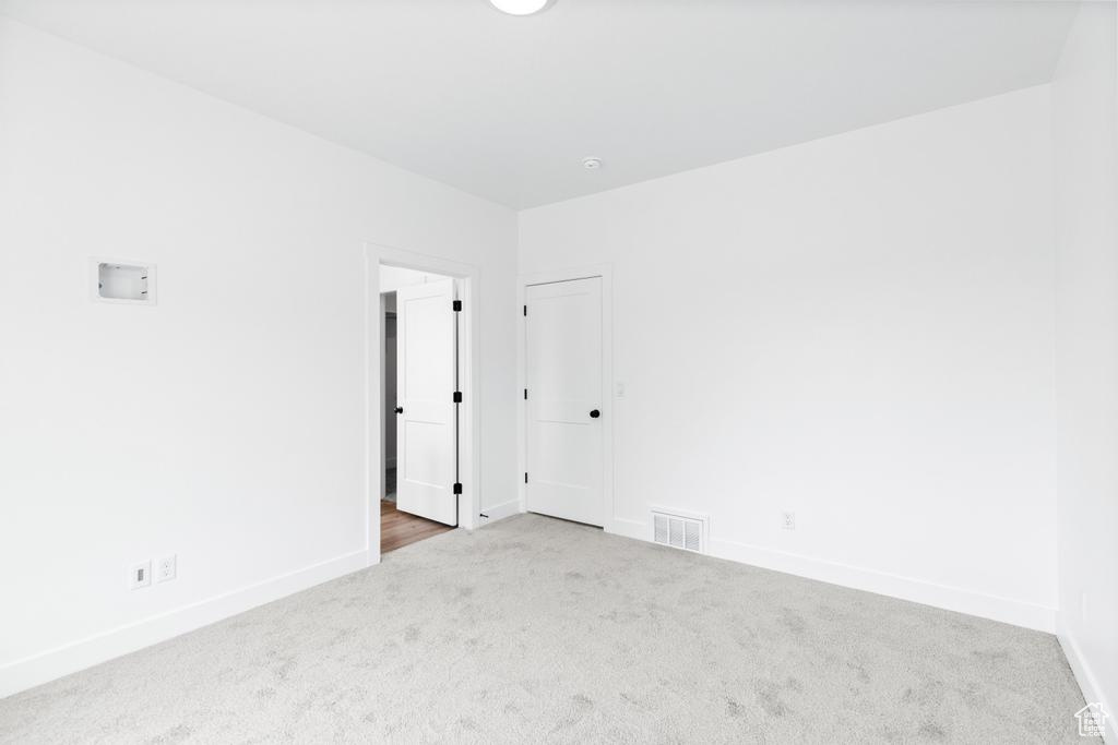 Spare room with carpet and baseboards