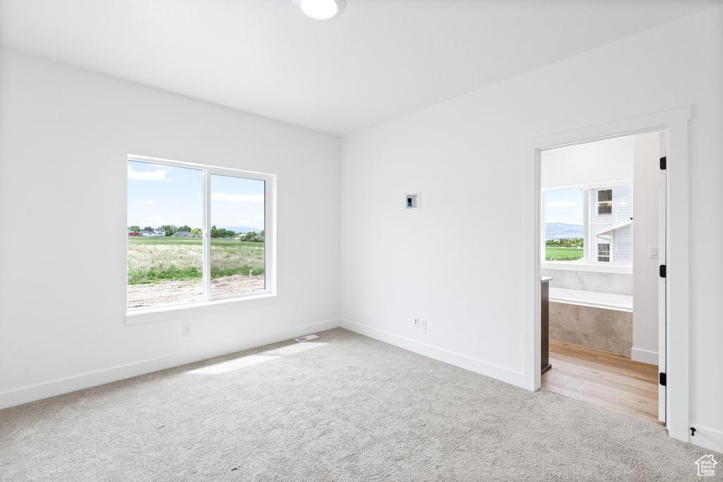 Carpeted empty room with baseboards