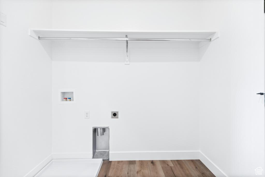 Clothes washing area featuring electric dryer hookup, hookup for a washing machine, and dark wood-style floors