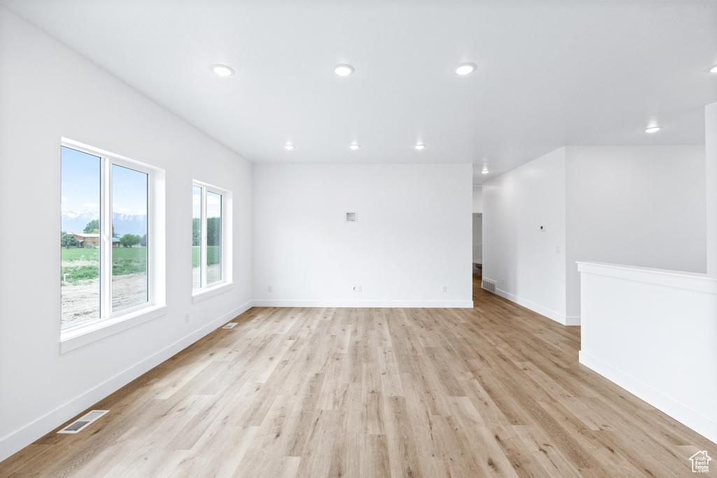 Unfurnished room with light wood-style floors, recessed lighting, and baseboards