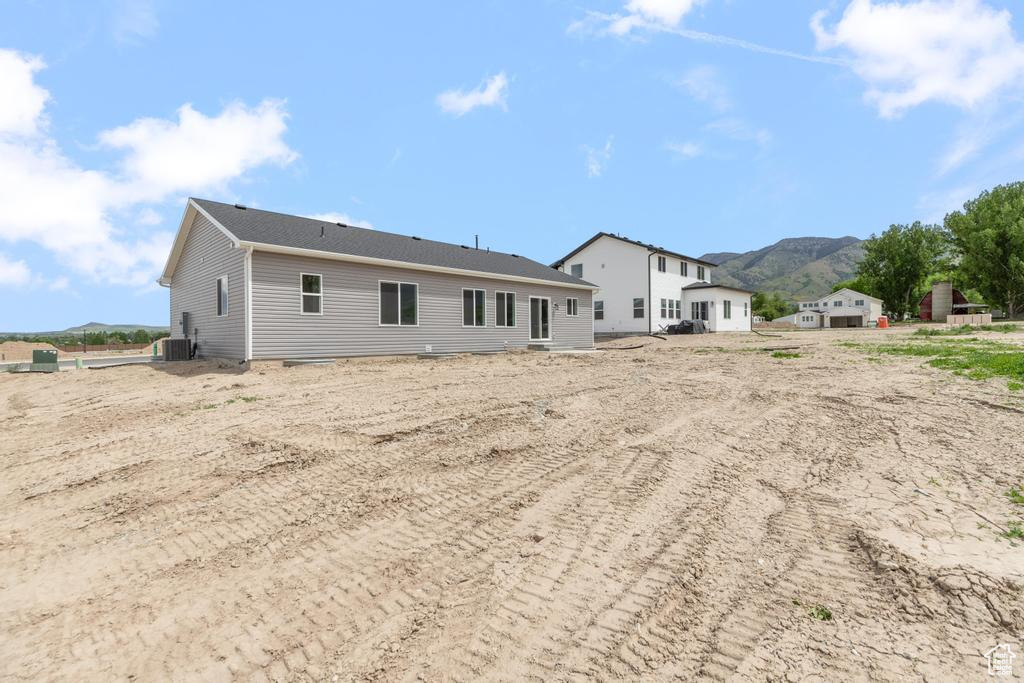 Rear view of property featuring central AC and a mountain view