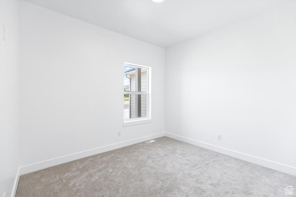 Unfurnished room featuring carpet flooring and baseboards