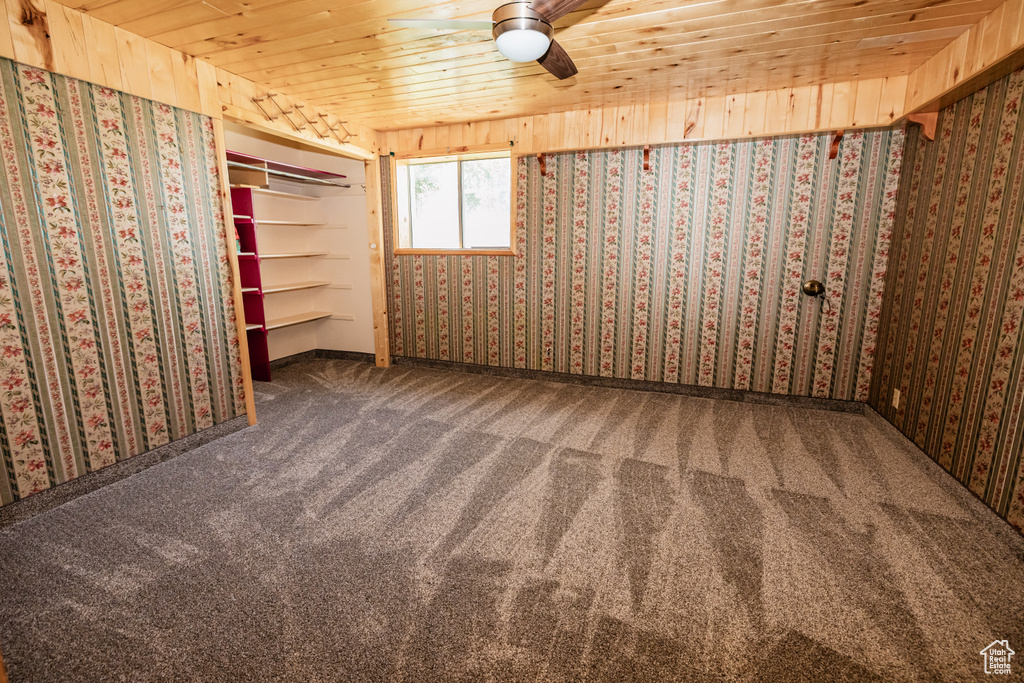 Spare room with carpet flooring and wooden ceiling