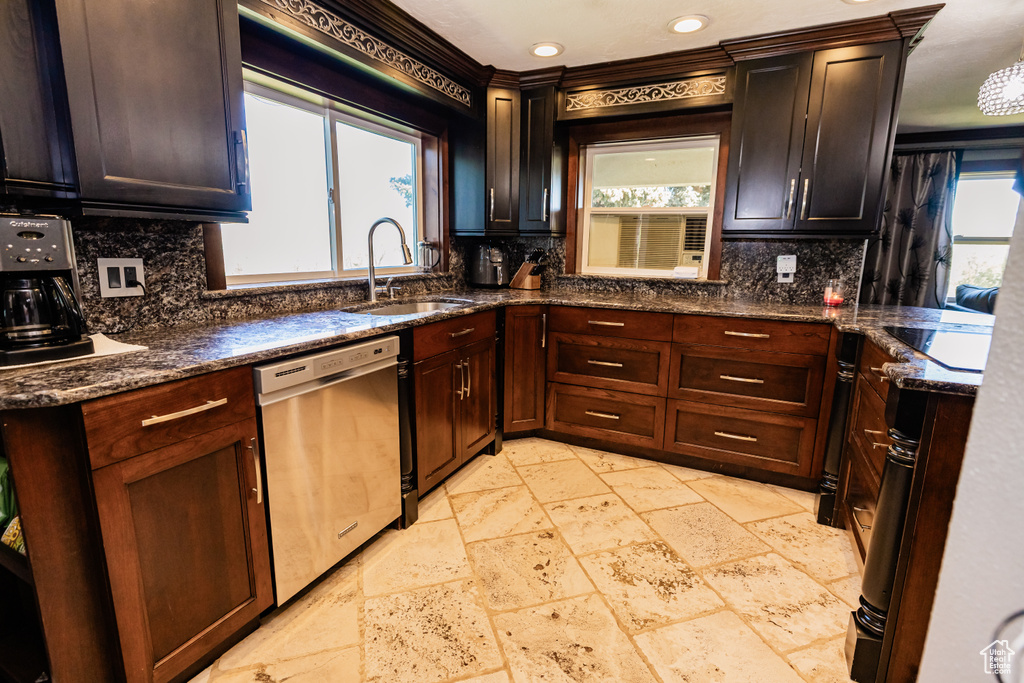 Kitchen with a sink, dishwasher, backsplash, stone tile floors, and recessed lighting