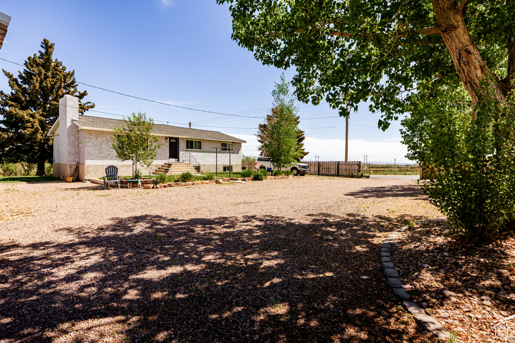 View of yard featuring fence