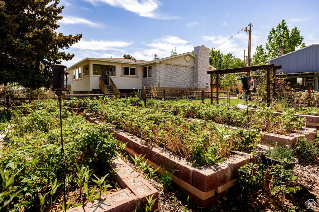 View of yard featuring a vegetable garden and fence