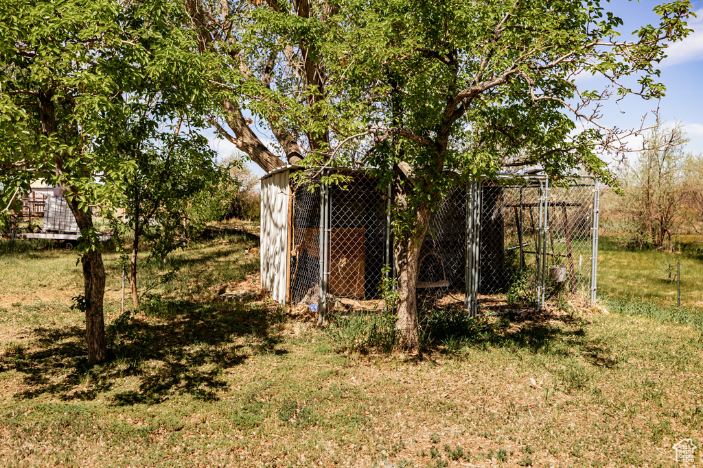 View of yard featuring an outdoor structure and exterior structure