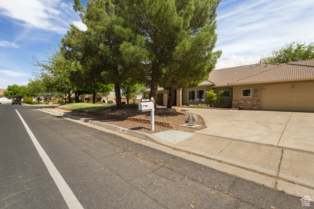 View of front of home featuring a tile roof and driveway