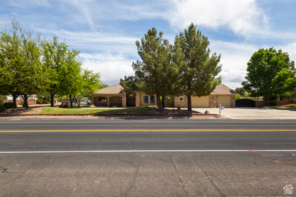 Obstructed view of property featuring concrete driveway and an attached garage