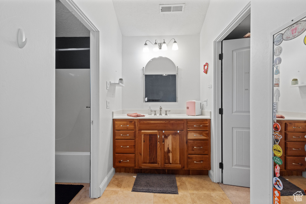 Bathroom with vanity and tile patterned flooring