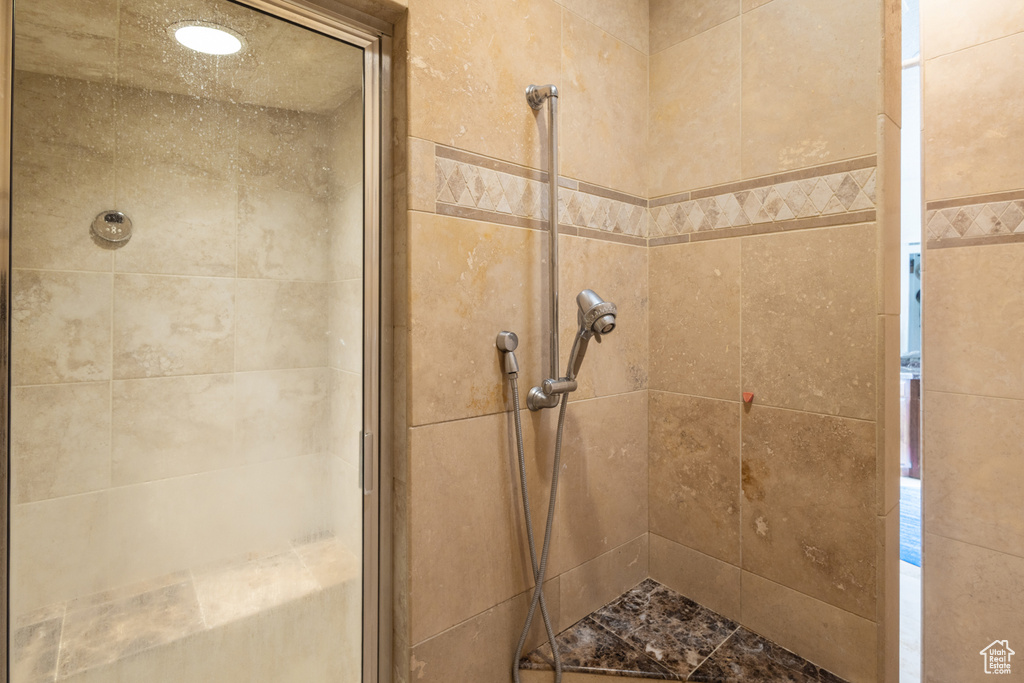 Full bathroom featuring a shower stall