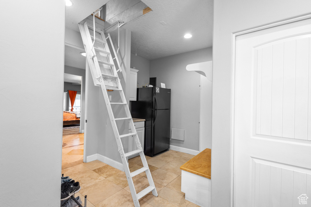 Hall featuring recessed lighting, baseboards, and light tile patterned floors