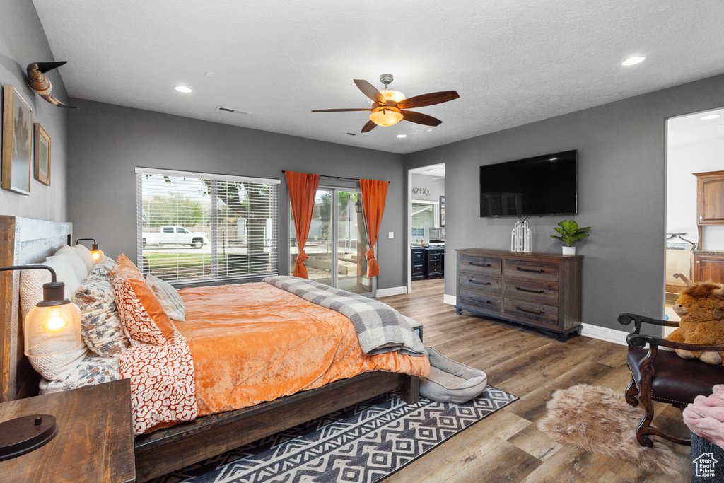 Bedroom featuring access to outside, baseboards, recessed lighting, wood finished floors, and a ceiling fan