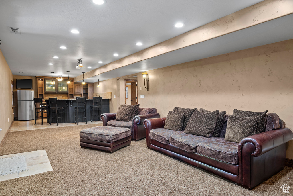 Living room with recessed lighting, carpet, and bar