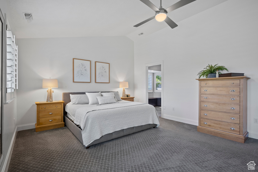 Bedroom featuring lofted ceiling, baseboards, dark colored carpet, and a ceiling fan