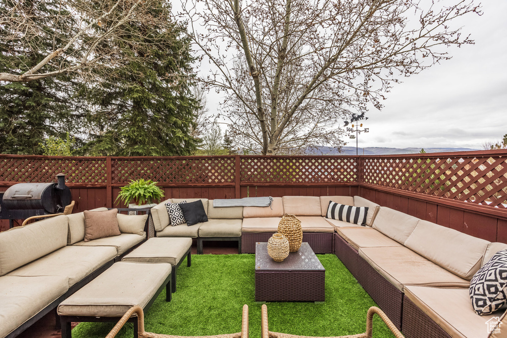 View of patio with outdoor lounge area and fence
