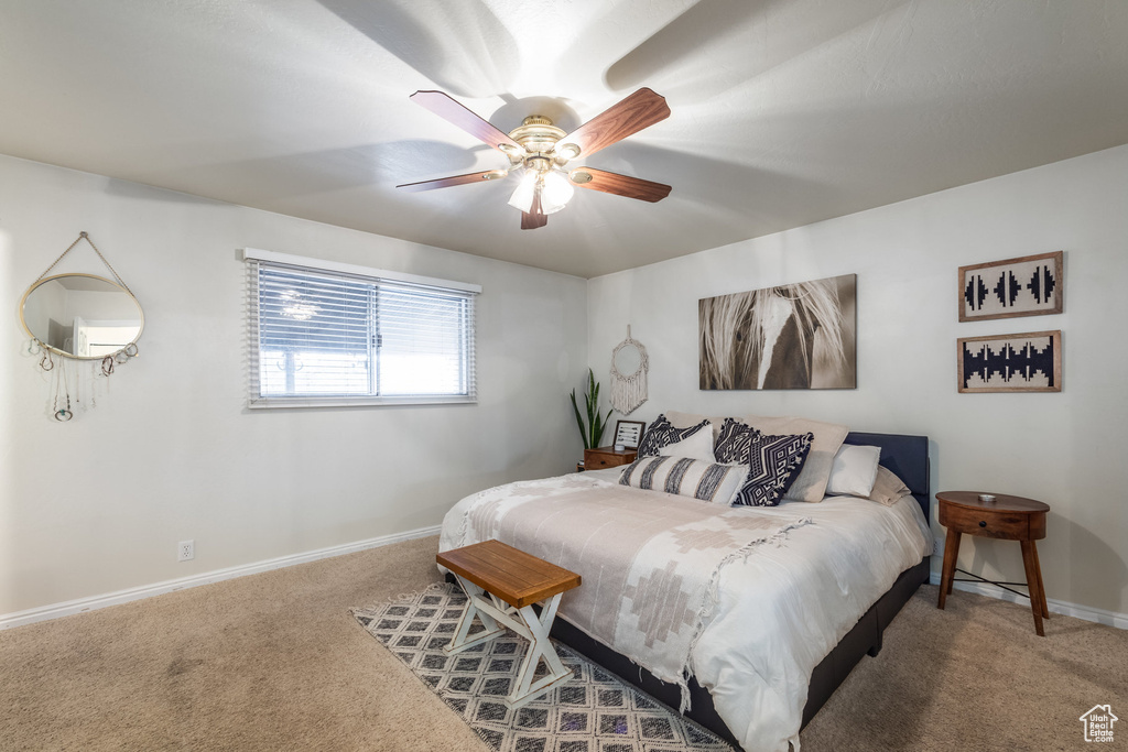 Bedroom with carpet floors, baseboards, and ceiling fan