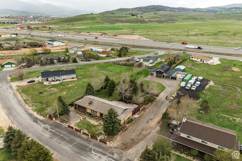 Aerial view of property's location featuring rural landscape, a mountain backdrop, and a main thoroughfare