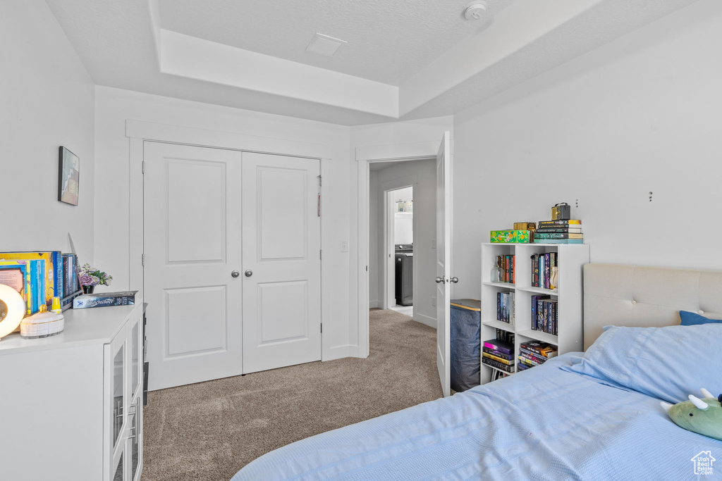 Bedroom with carpet flooring and a closet