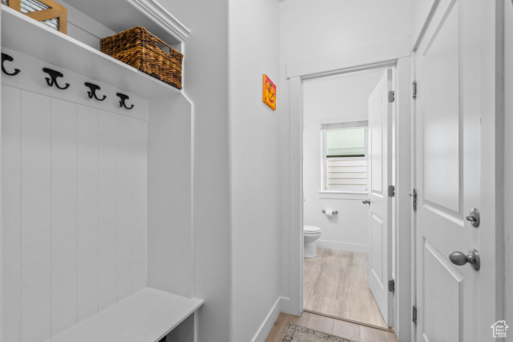Mudroom with light wood-style flooring and baseboards