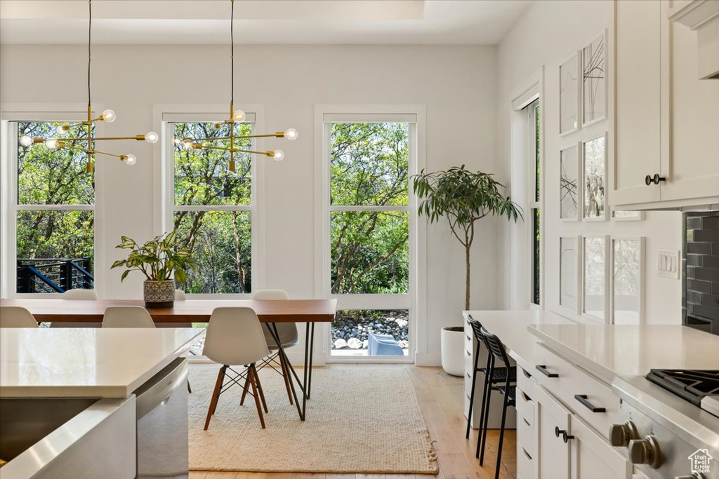 Dining space featuring a chandelier and light wood-type flooring