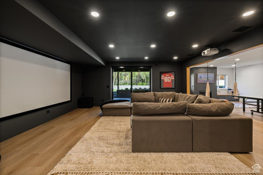 Cinema room with recessed lighting and light wood-style flooring